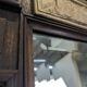Renaissance-style mirror in wood and copper with a craftsmanship theme.