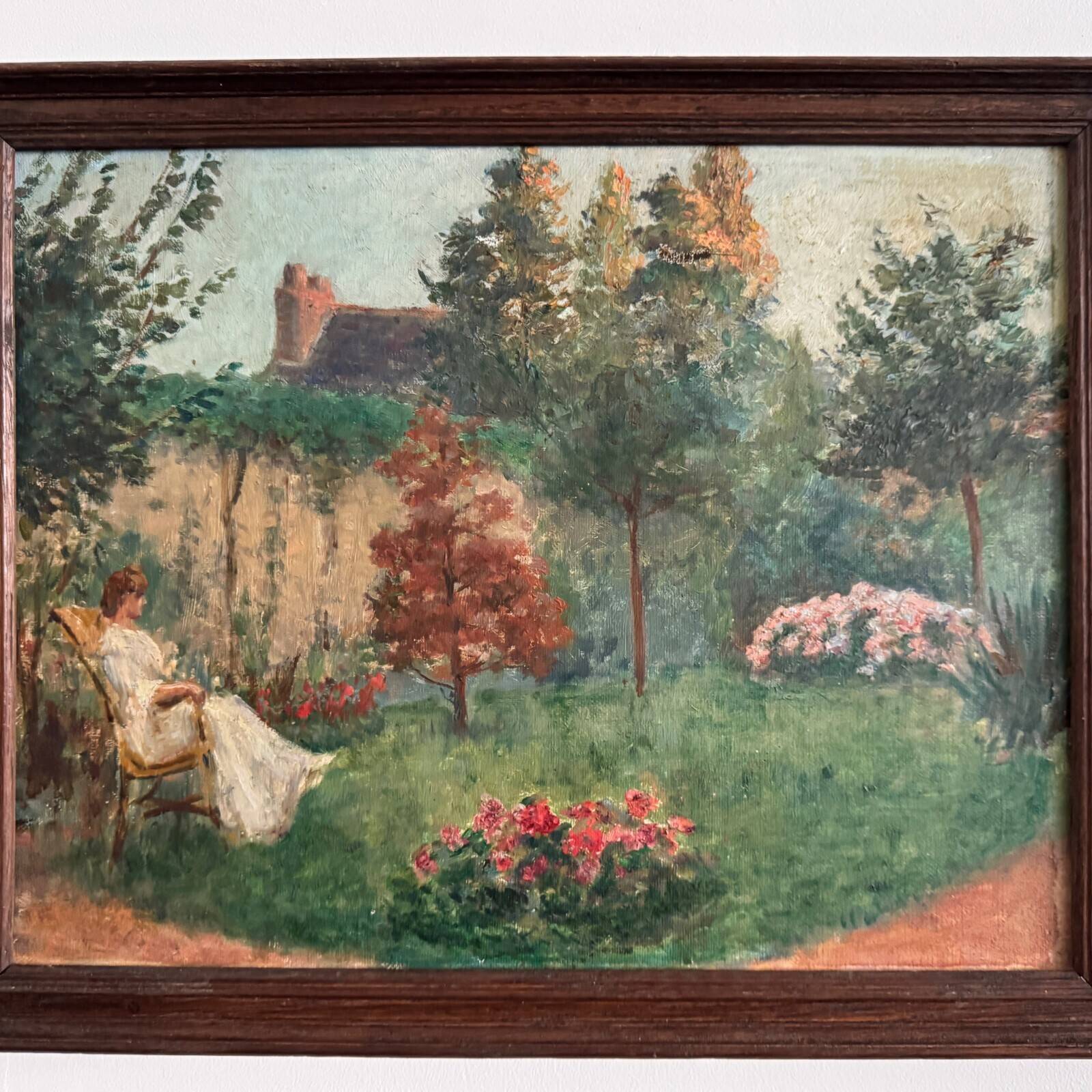Oil on canvas park scene with a woman sitting in an armchair