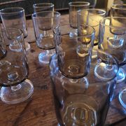 12 smoked glass stemmed glasses from the 70s and 80s.