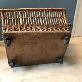 Rattan laundry basket on vintage wheels