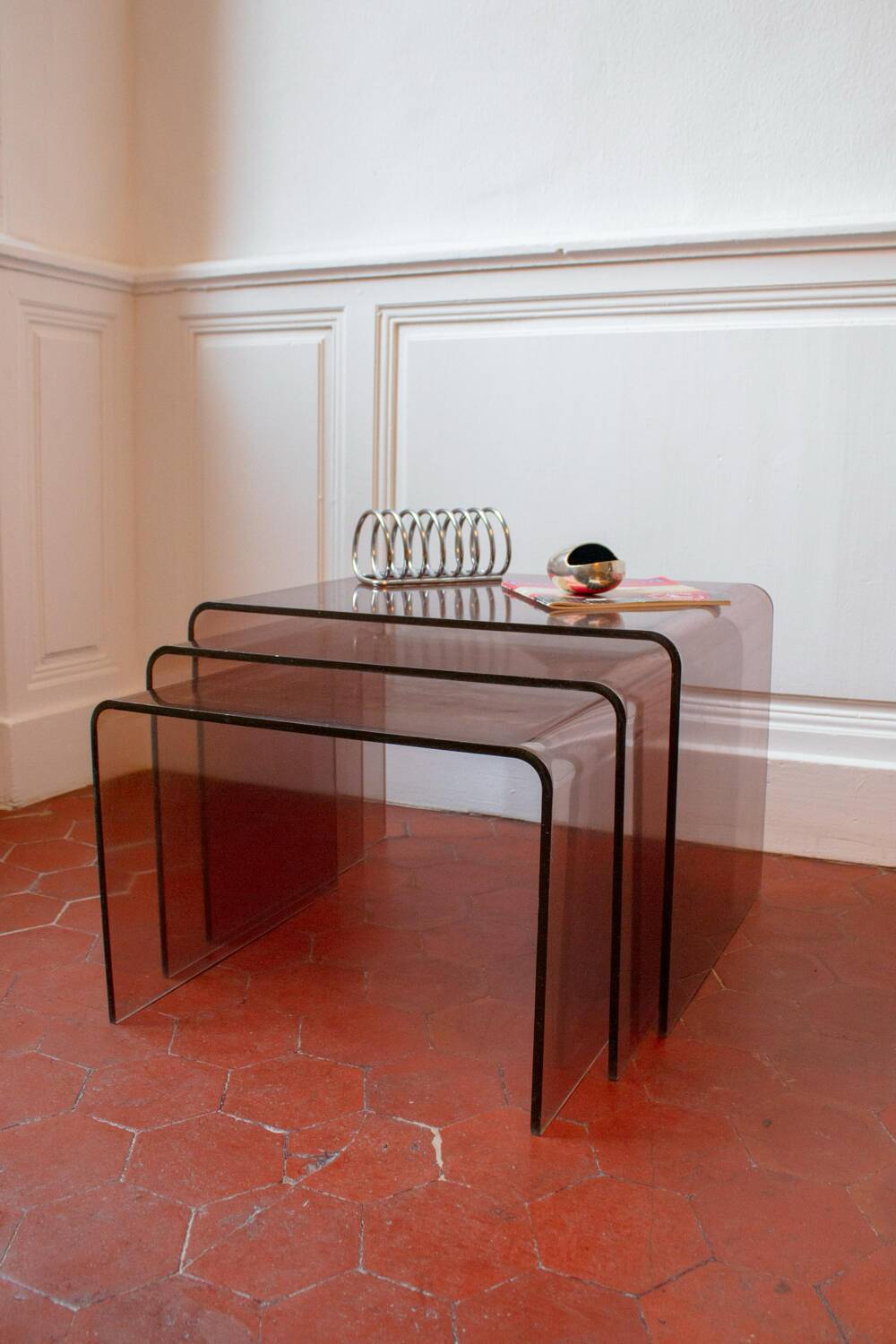 Vintage trio of nesting tables in smoked plexiglass by Michel Dumas, year.