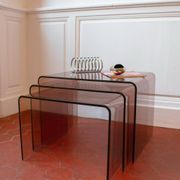 Vintage trio of nesting tables in smoked plexiglass by Michel Dumas, year.