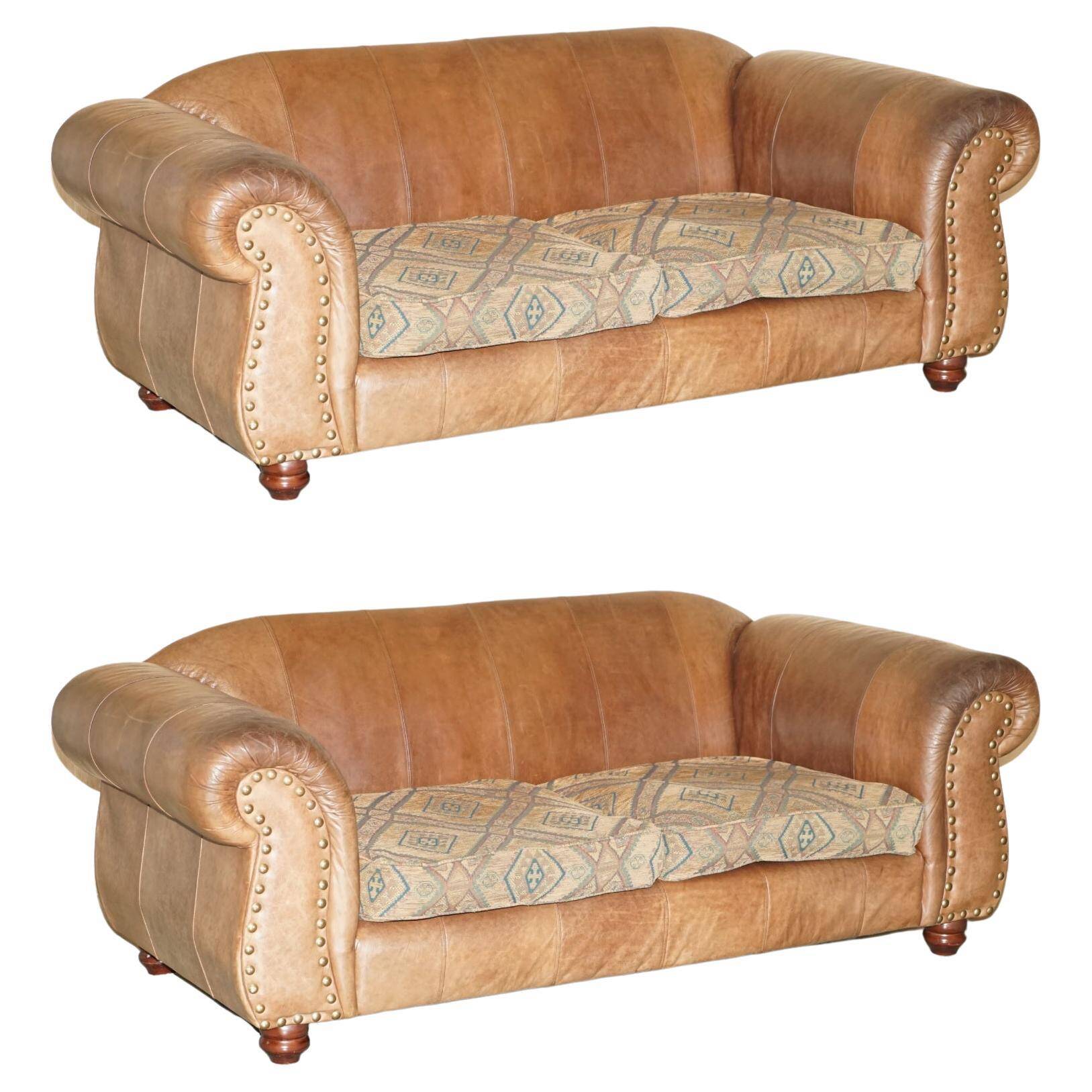 Vintage leather sofas by Thomas Lloyd with Kilim cushions.
