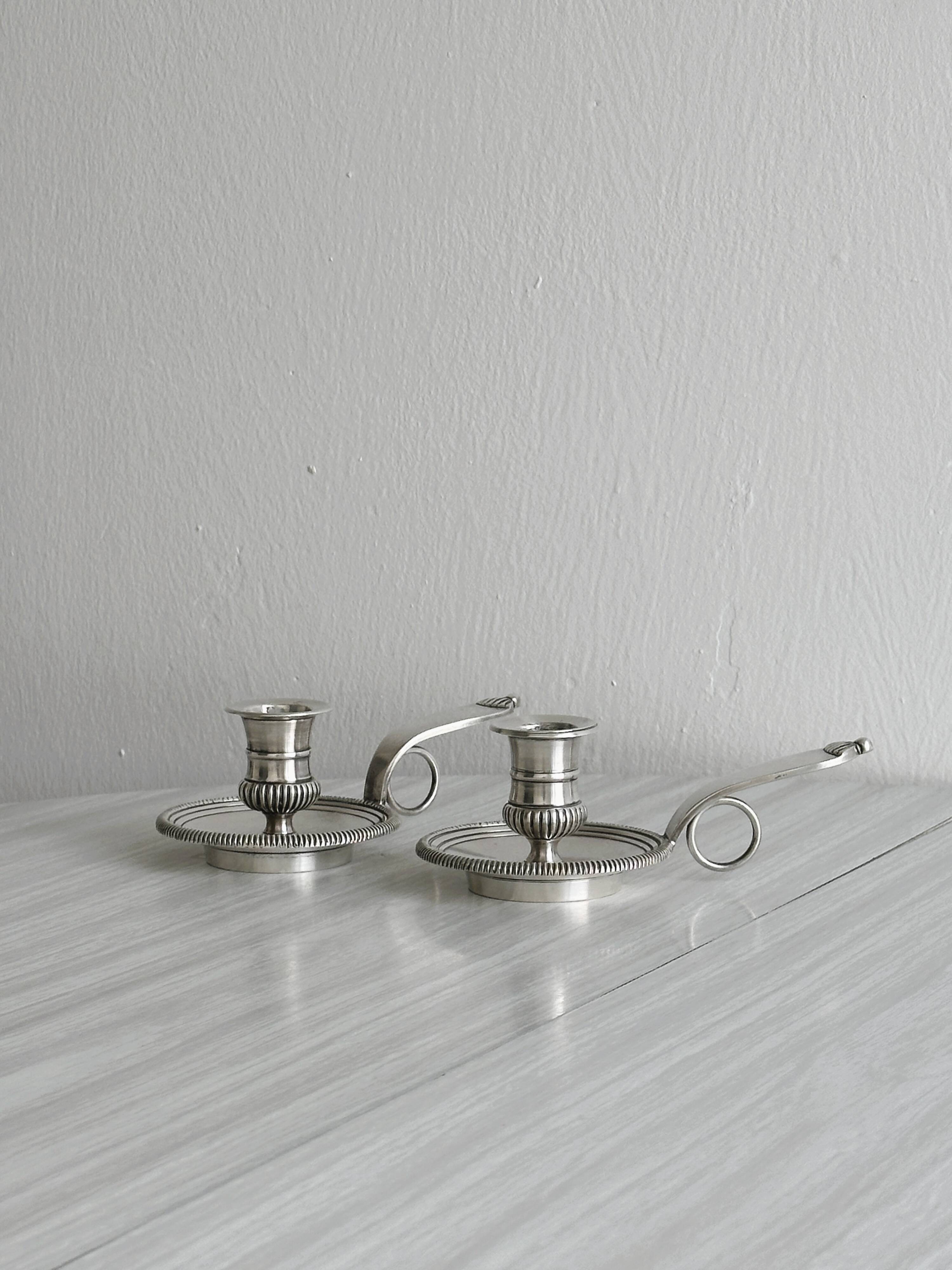 Pair of shiny silver metal candlesticks