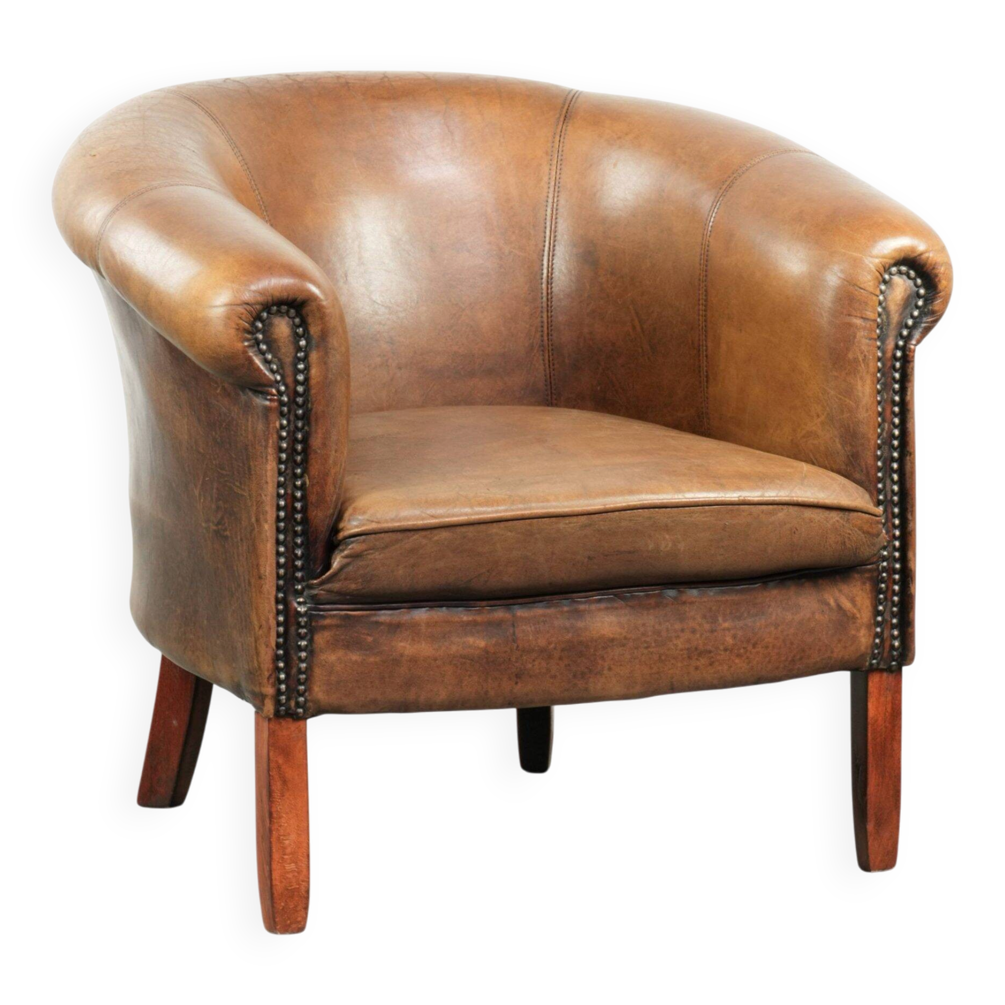 Sheepskin club armchair in a brown colour finished with decorative nails