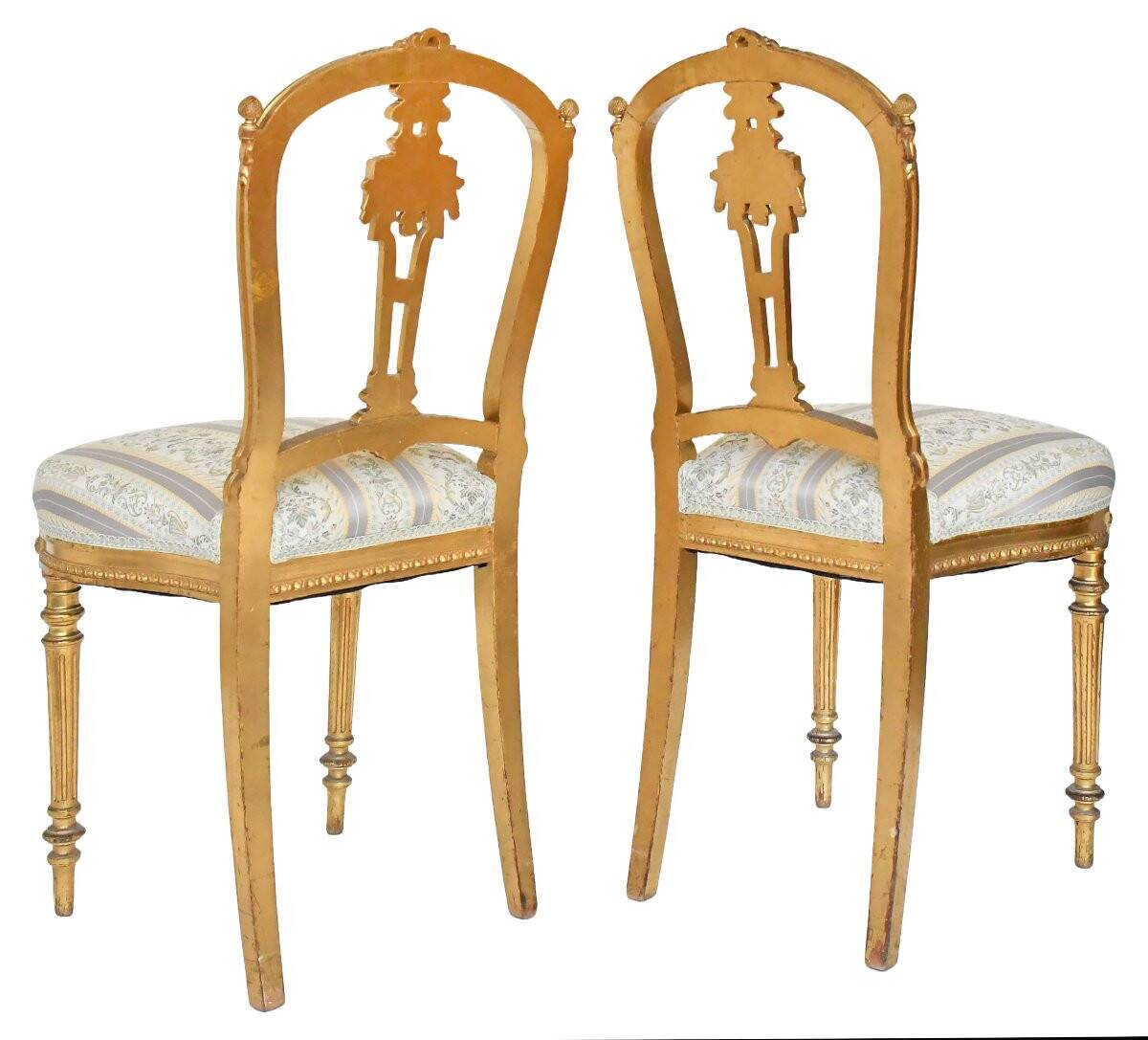Pair of Louis XVI style chairs in gilded wood.