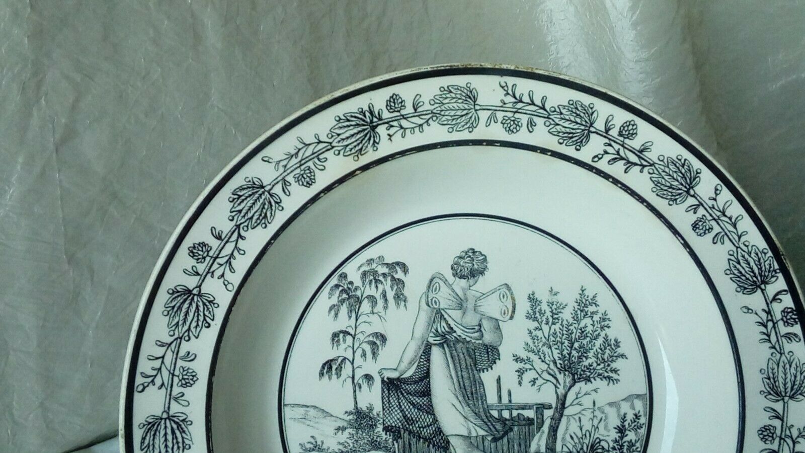 CHOISY HOLLOW PLATE IN FINE FAIENCE ON THE THEME OF THE MONTHS "APRIL"