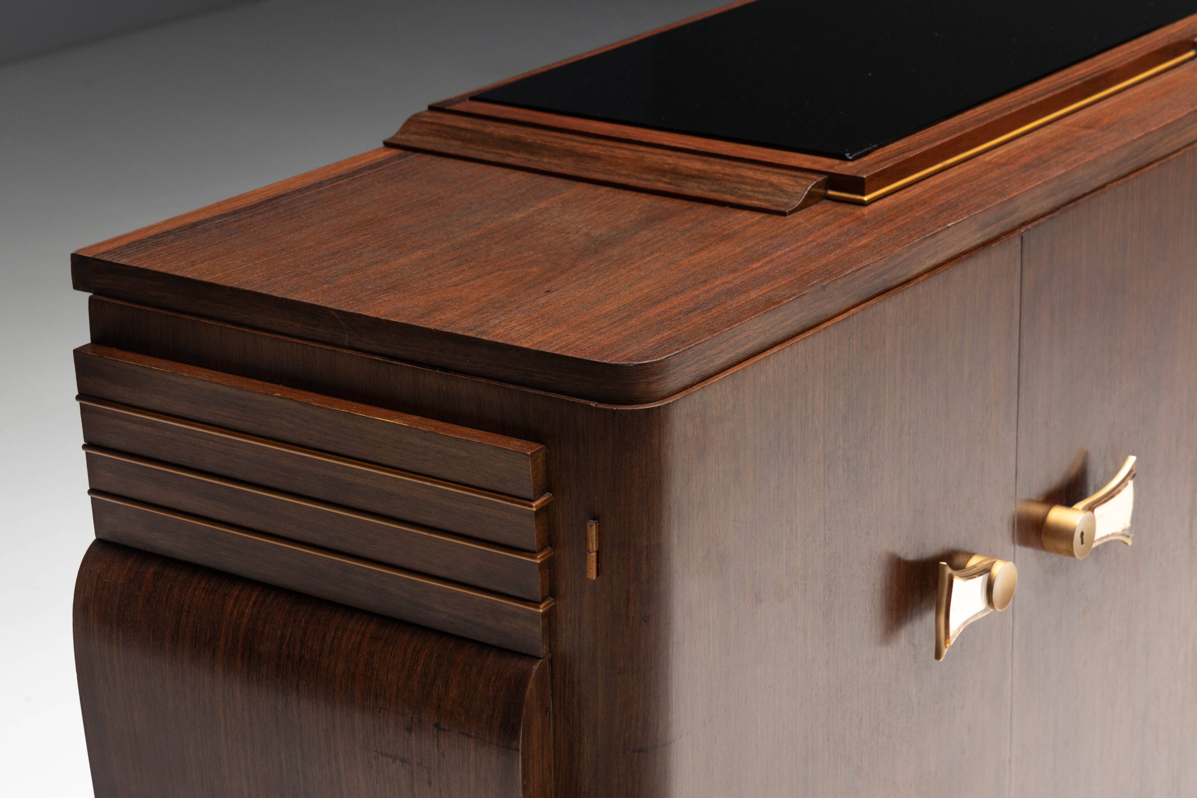 Art Deco walnut sideboard with brass details and sculptural base, France, 1930s