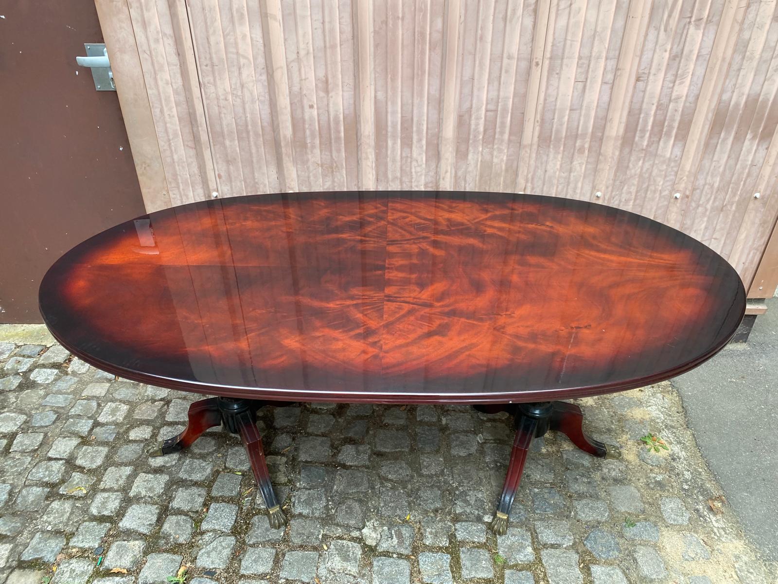 Glossy mahogany dining table in English Regency style from the 1970s.
