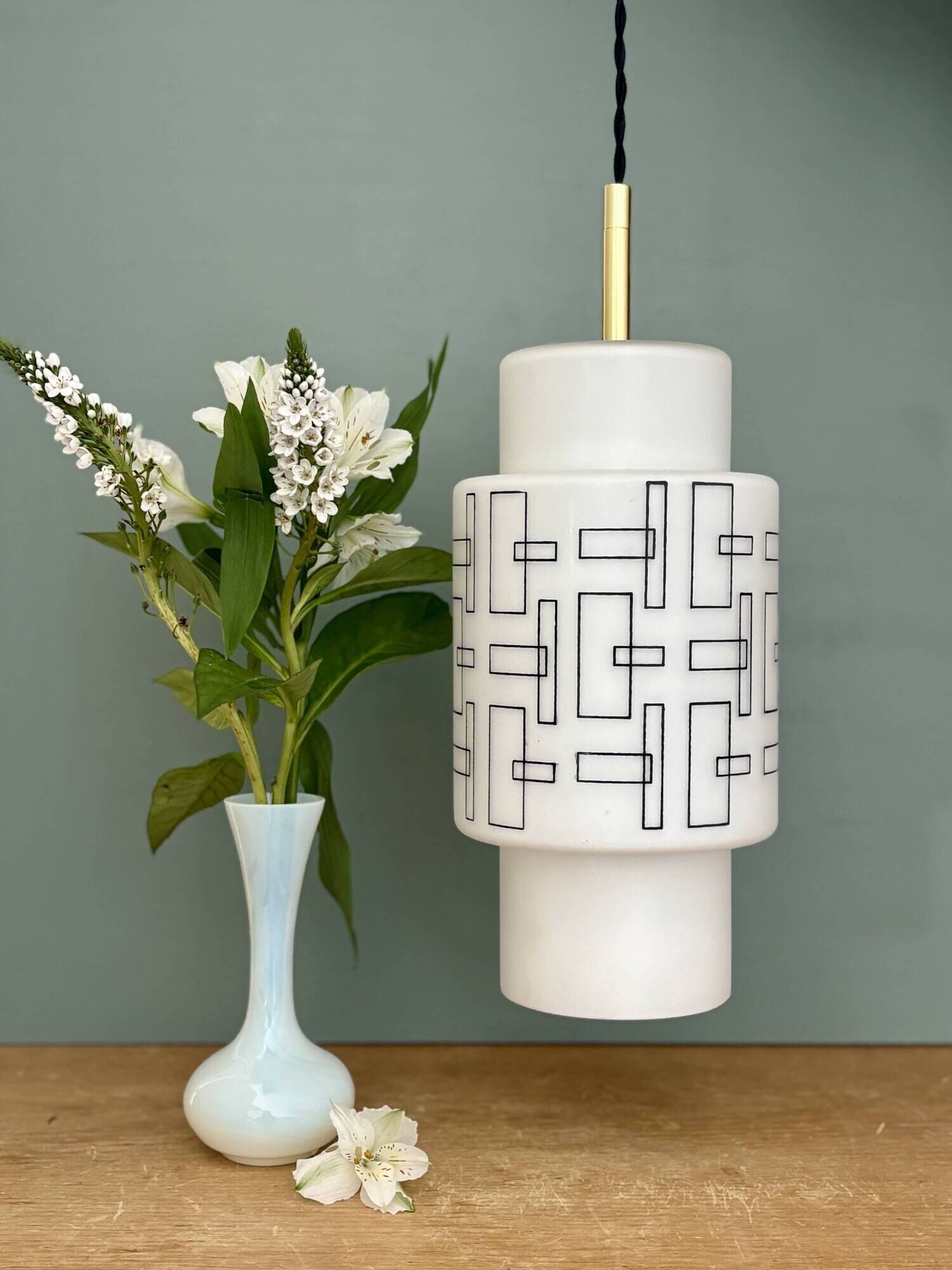 Vintage suspension globe in white opaline with black drawings.