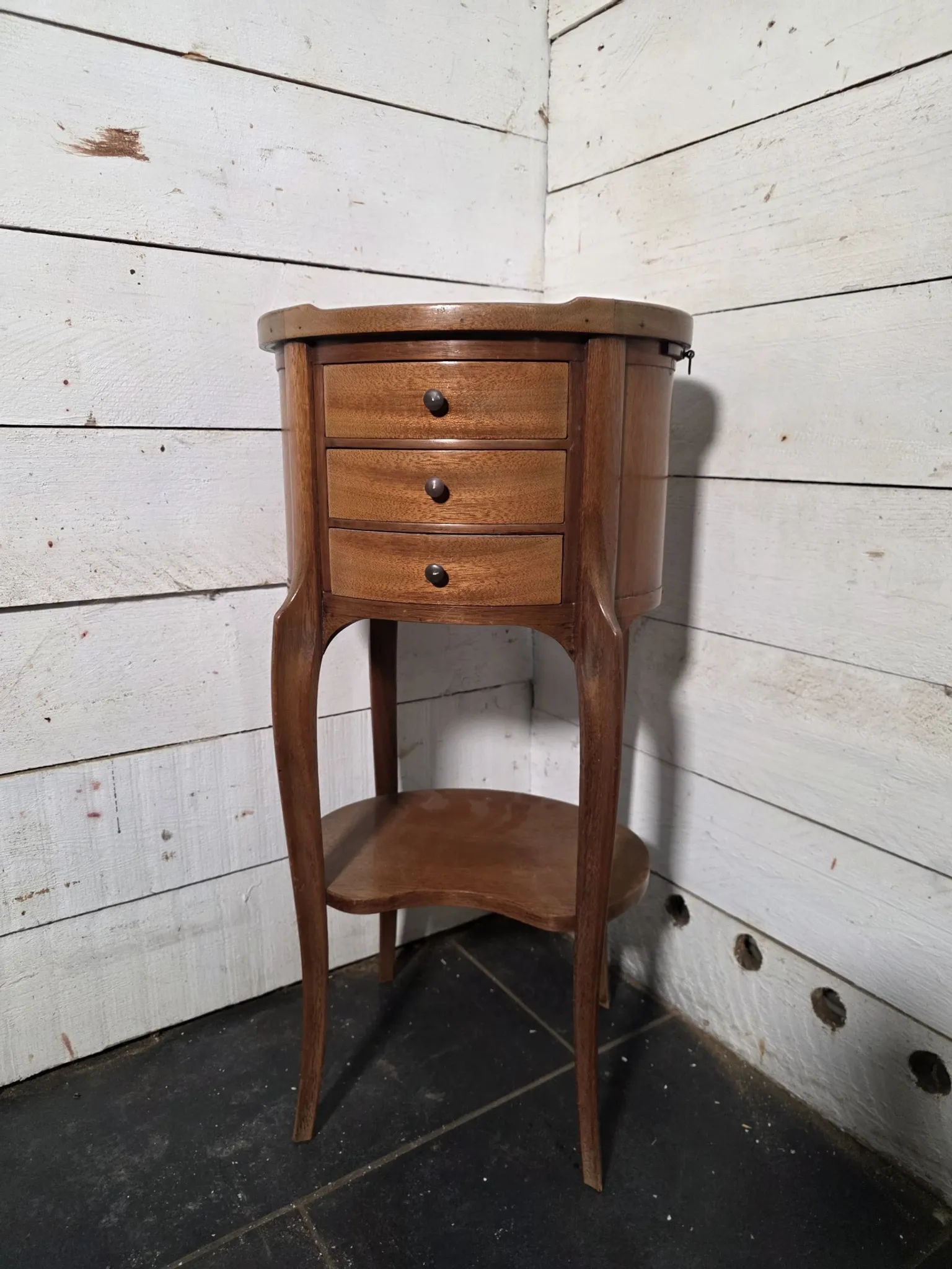 Oval bedside table in Louis XV style made of mahogany.