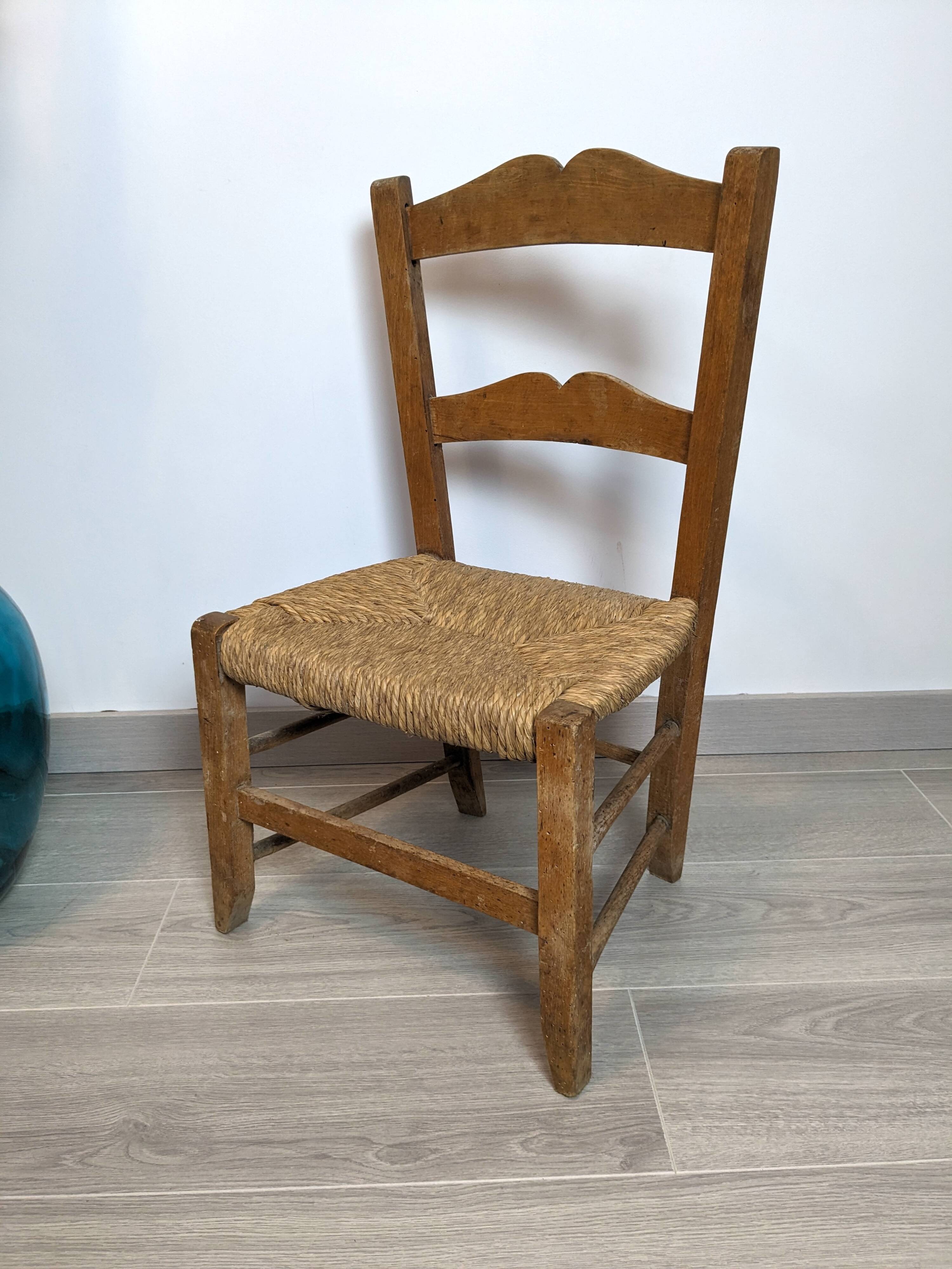 Vintage wooden and straw children's chair in a country style.