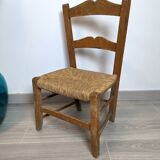 Vintage wooden and straw children's chair in a country style.