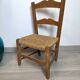 Vintage wooden and straw children's chair in a country style.