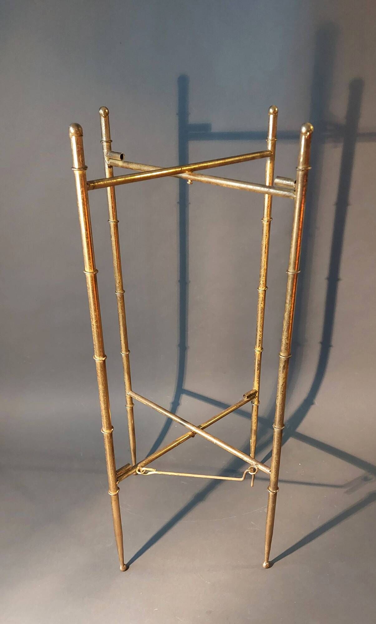 Pedestal table in patinated gilded brass faux foldable bamboo.