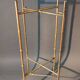 Pedestal table in patinated gilded brass faux foldable bamboo.