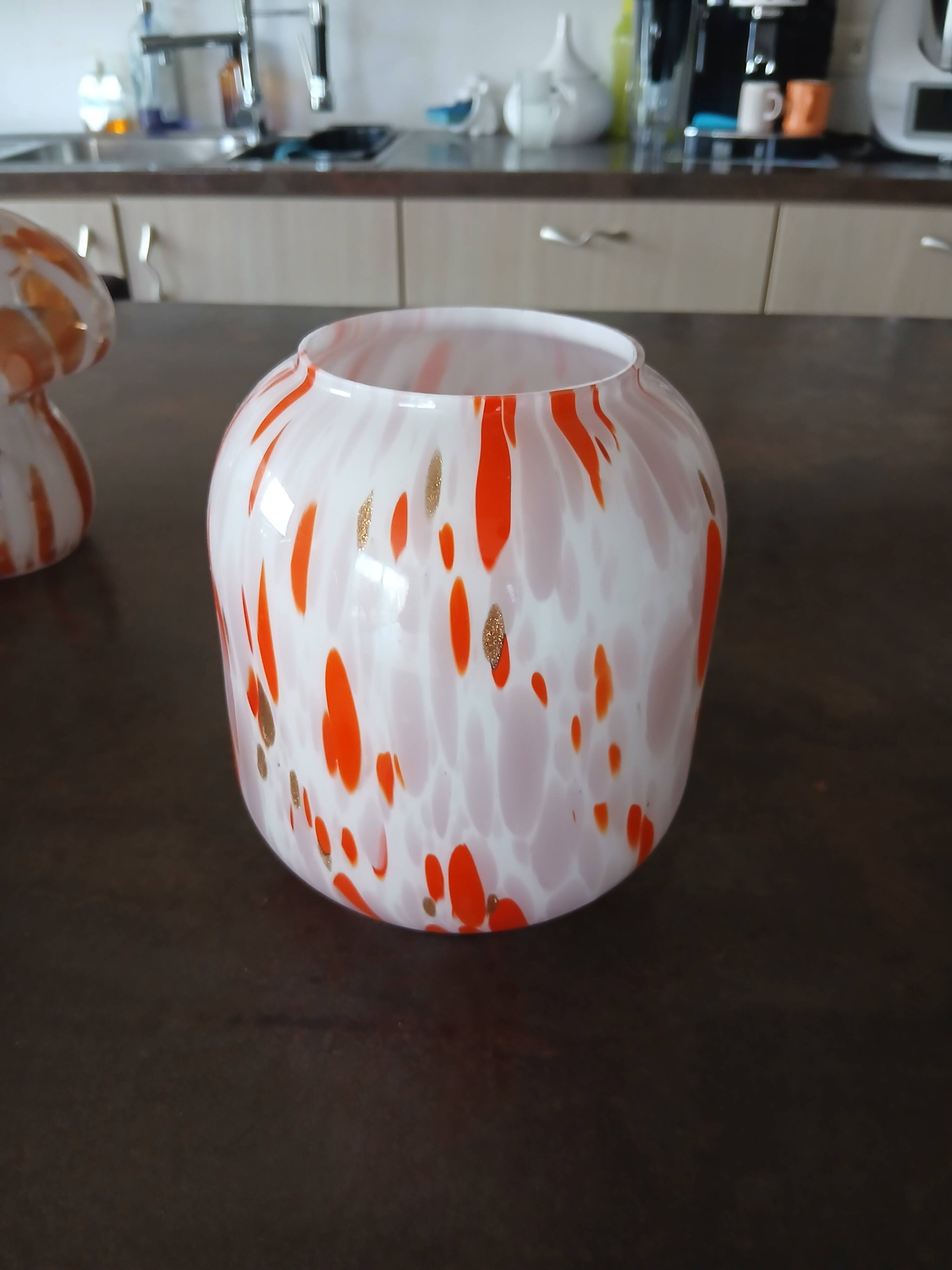 Vintage orange and white glass lamp with golden accents.