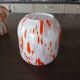 Vintage orange and white glass lamp with golden accents.