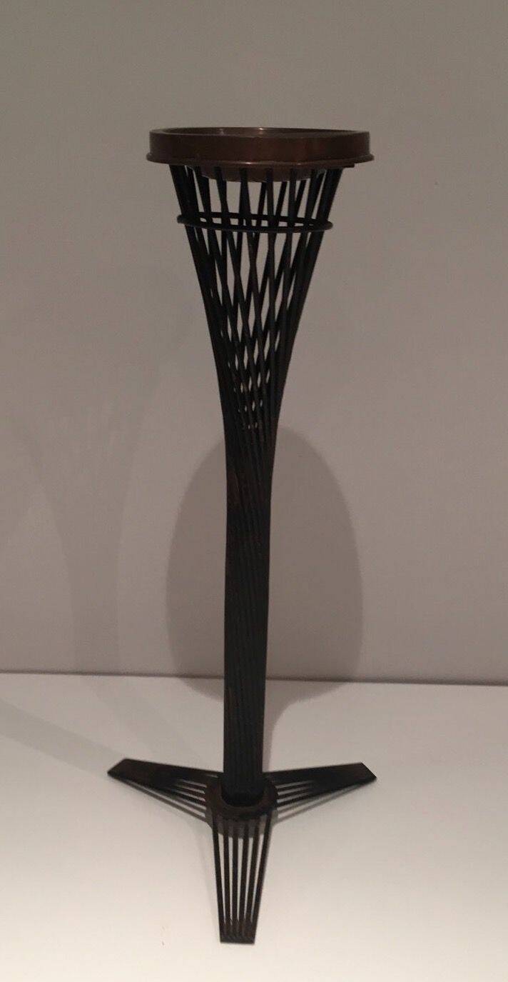 Brass ashtray on a stand made of black lacquered metal wire.