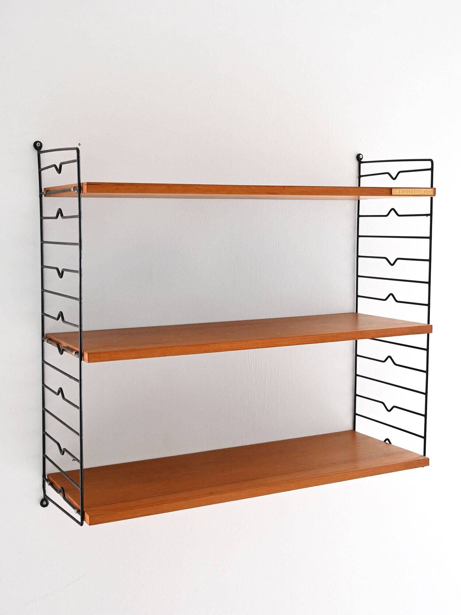 Scandinavian Hylla teak wall shelf with brass label