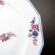 4 flat plates by Bernardaud, Limoges porcelain, floral decoration from the 1920s to 1950s.