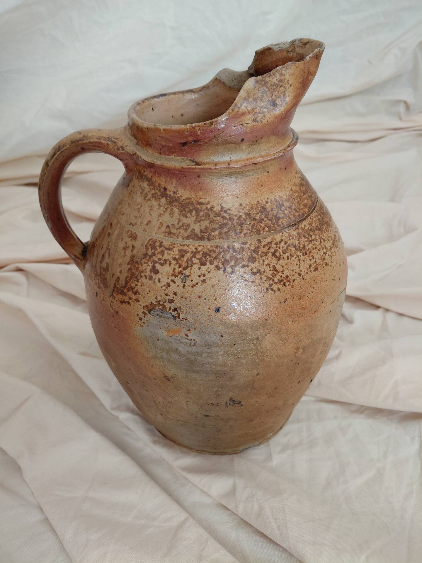 Old farm jug in glazed stoneware