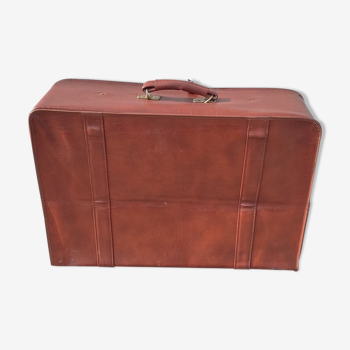 Old brown suitcase in skaï