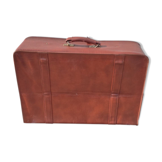 Old brown suitcase in skaï