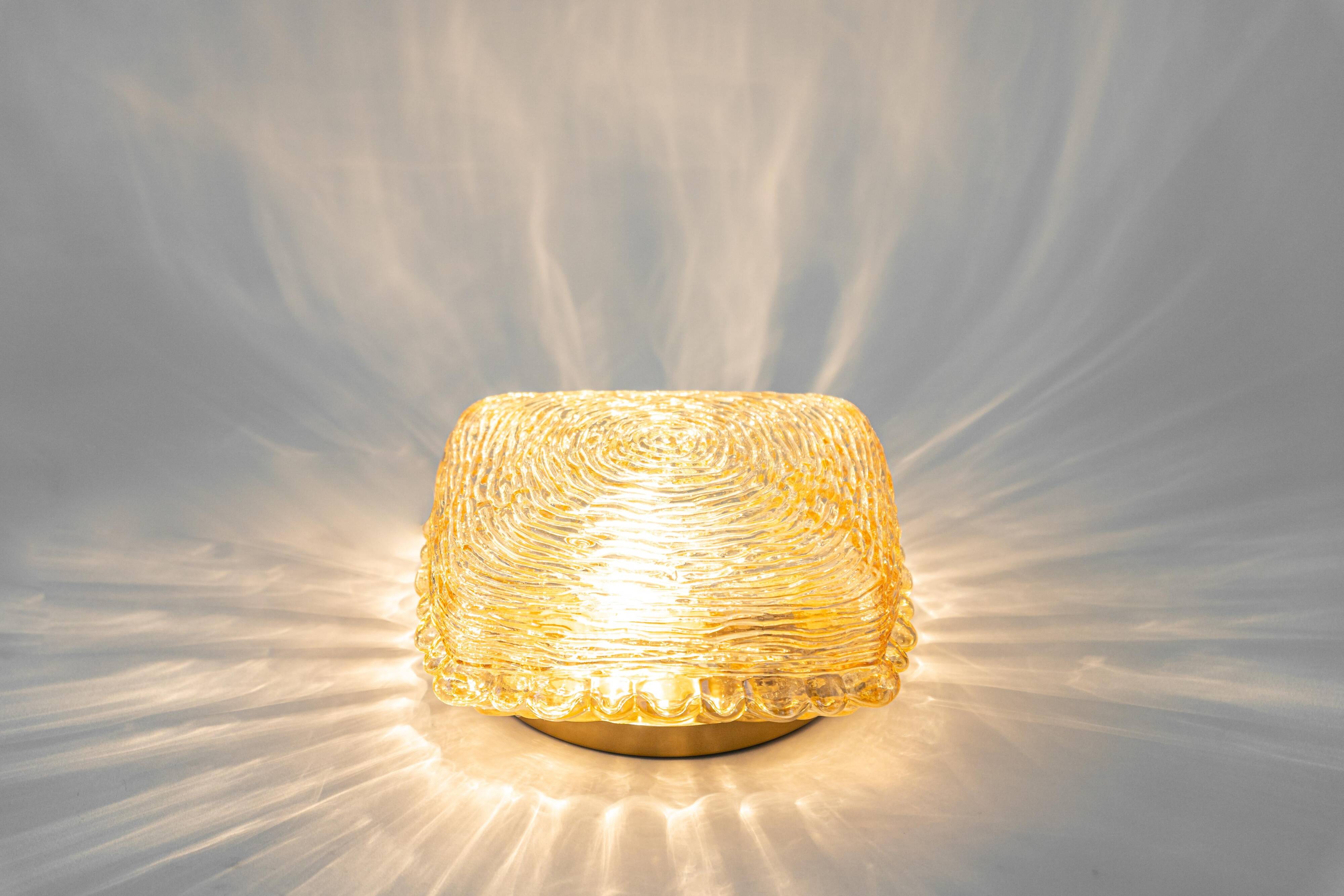 Pairs of amber glass wall lights in the shape of a fingerprint, Germany, 1970s.