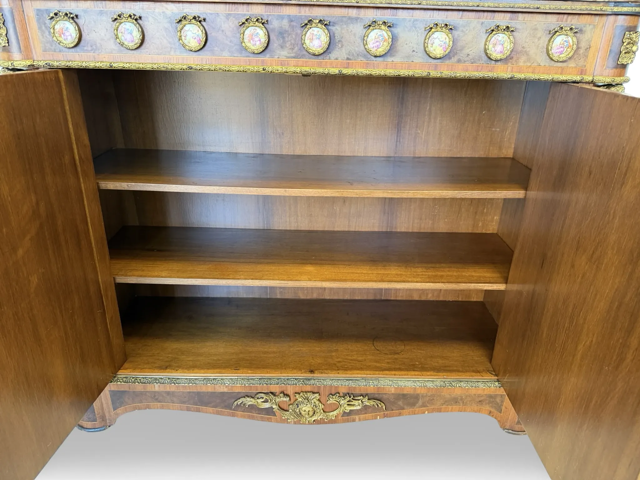 An antique French Louis XVI-style marble-top side cabinet