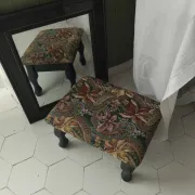 Petit ottoman repose-pied tapisserie vintage.