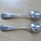 2 small white metal spoons