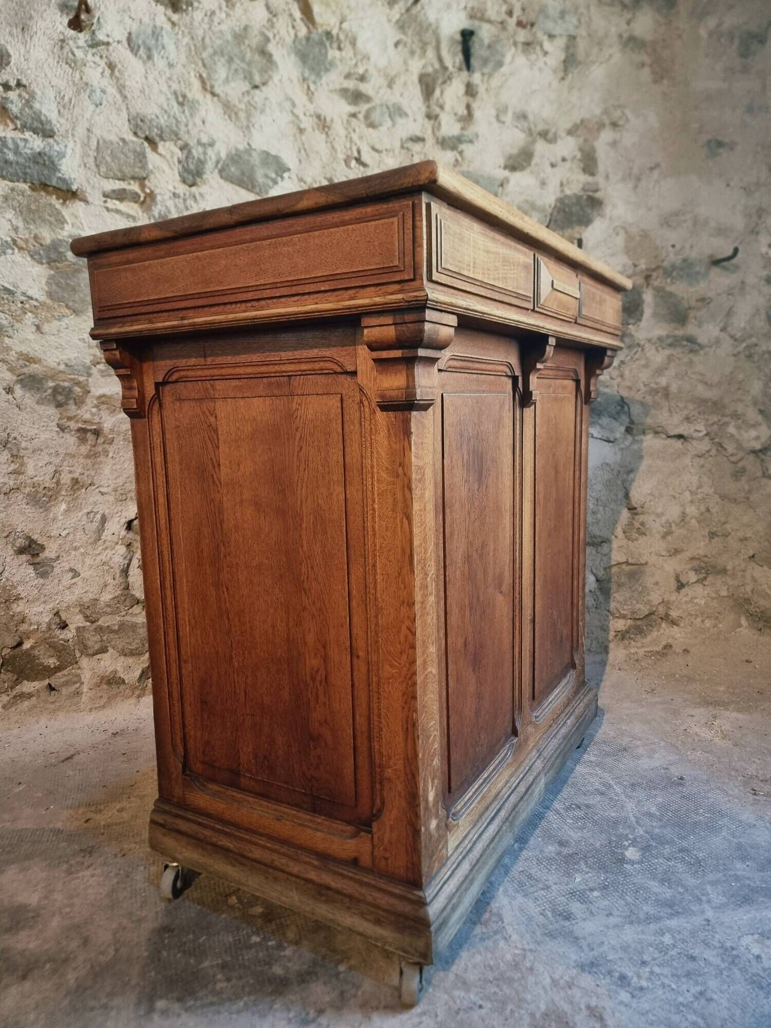 Antique French oak shop counter, kitchen island on wheels, circa 1880–1900.