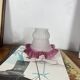 Antique tulip lampshade in transparent glass with a red rim.