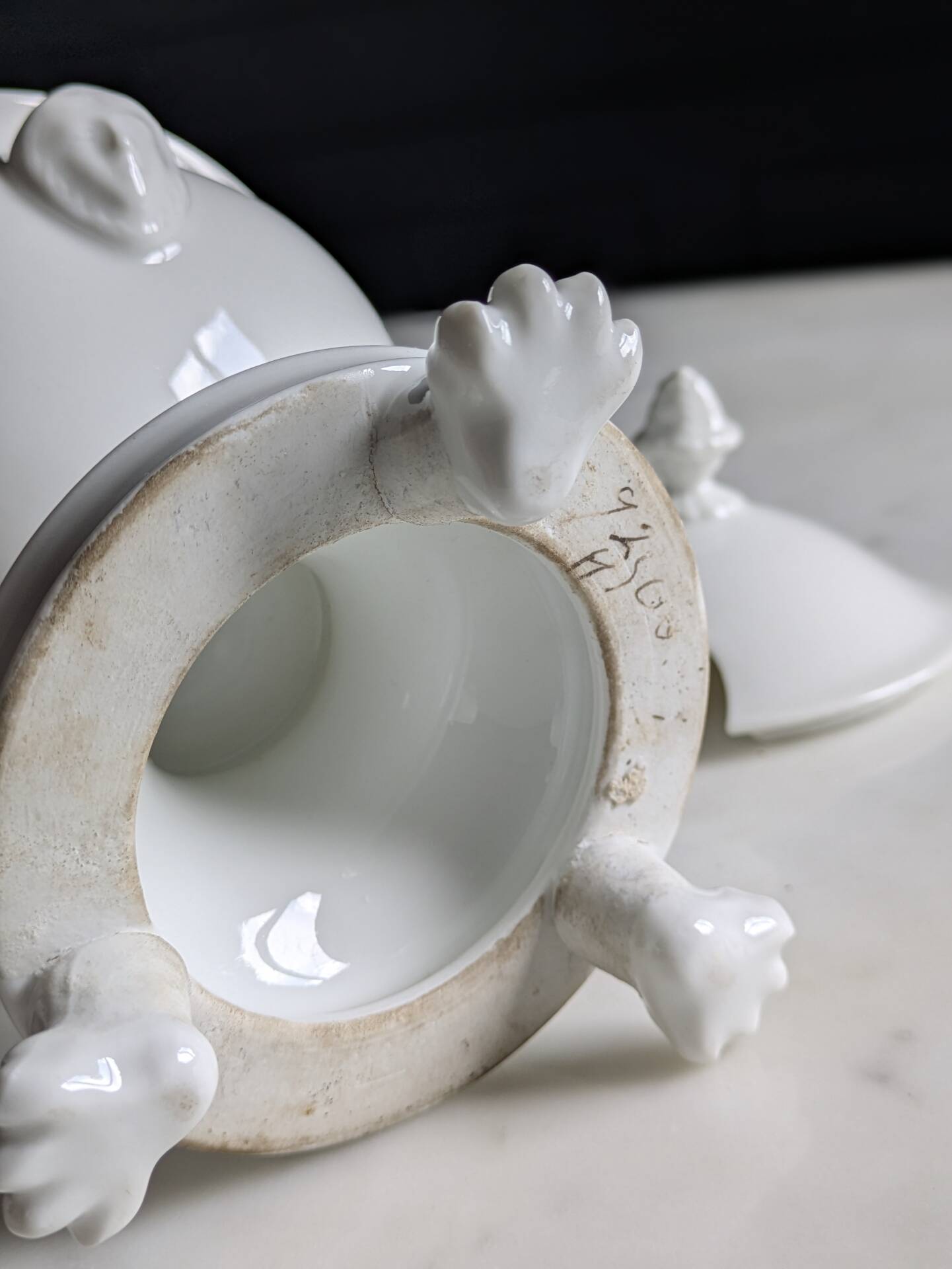 White porcelain confiturier with lion paws and masks. 19th century.