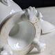 White porcelain confiturier with lion paws and masks. 19th century.