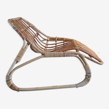 Elongated rattan armchair