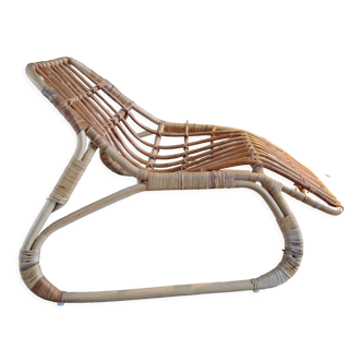 Elongated rattan armchair