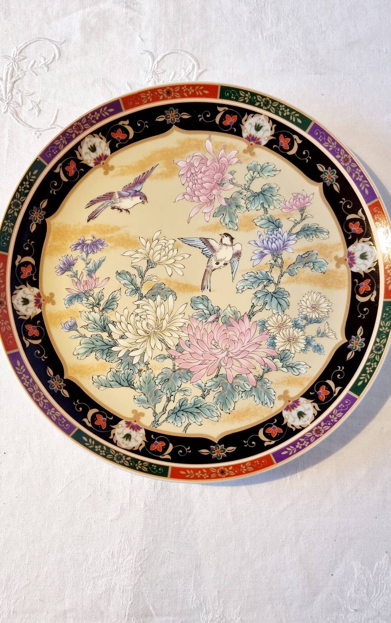 Vintage Japanese decorative plate with chrysanthemum and bird patterns.