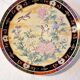 Vintage Japanese decorative plate with chrysanthemum and bird patterns.