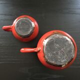Pair of red pitchers