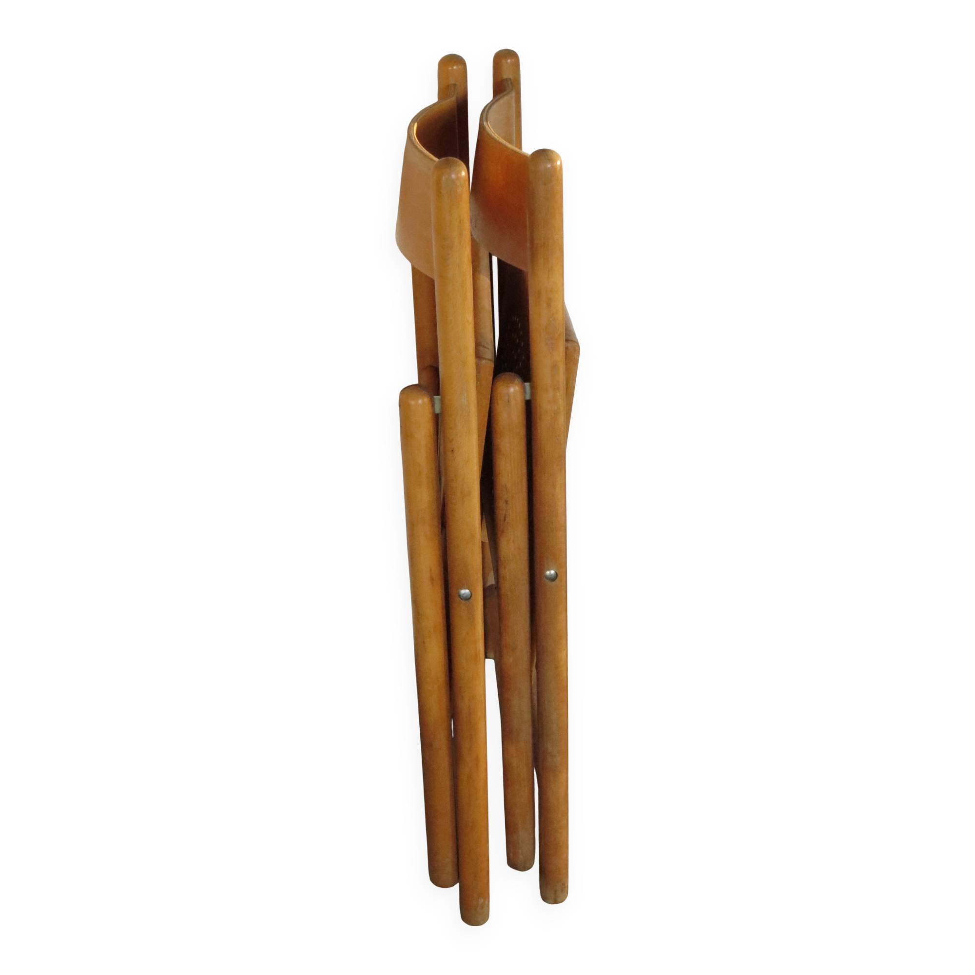 Pair of vintage wooden folding chairs with star pattern on seat