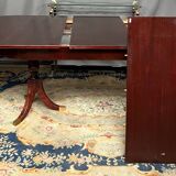 Empire style dining table with two sliding elements.