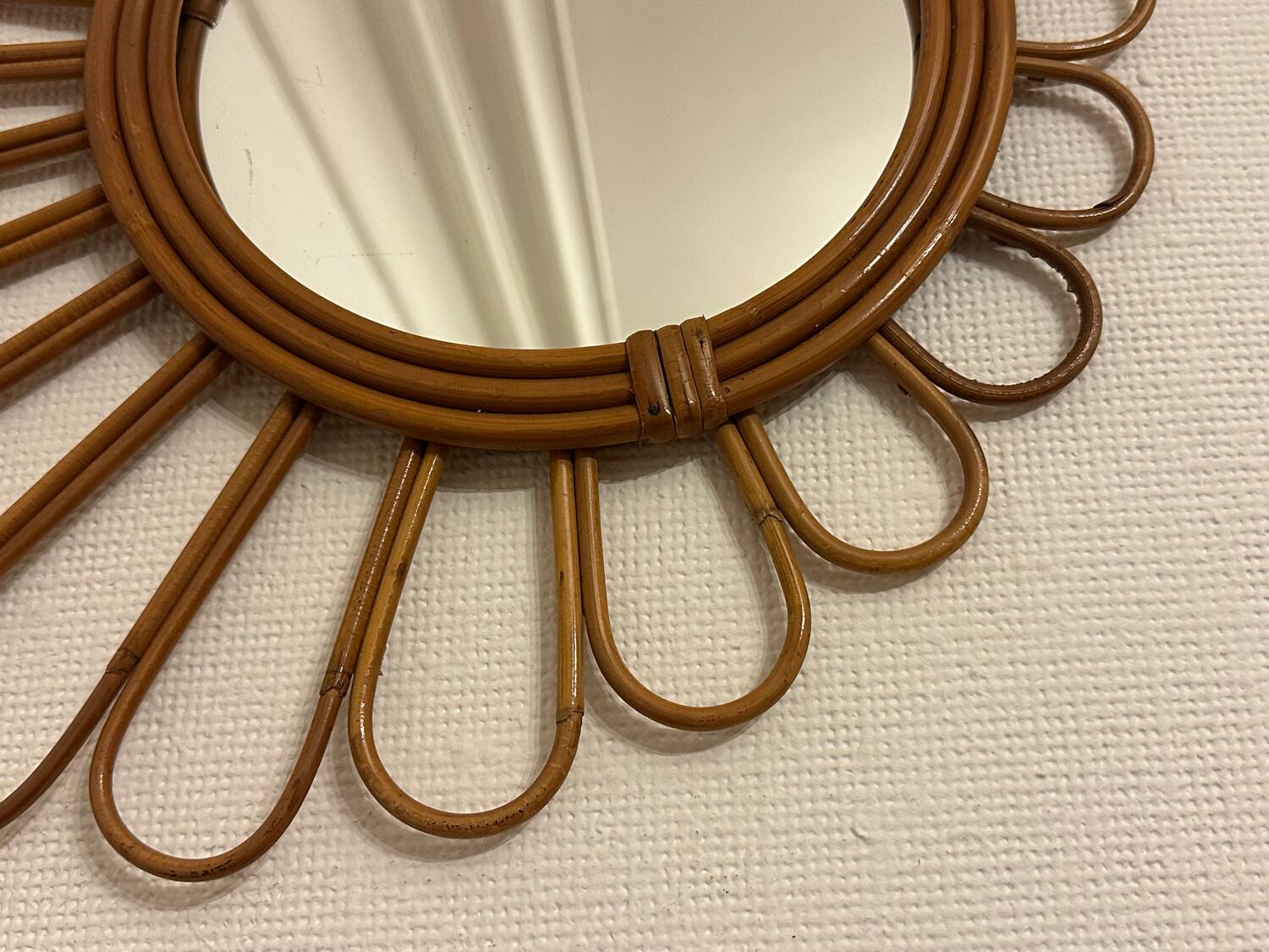 Old vintage asymmetrical round rattan mirror