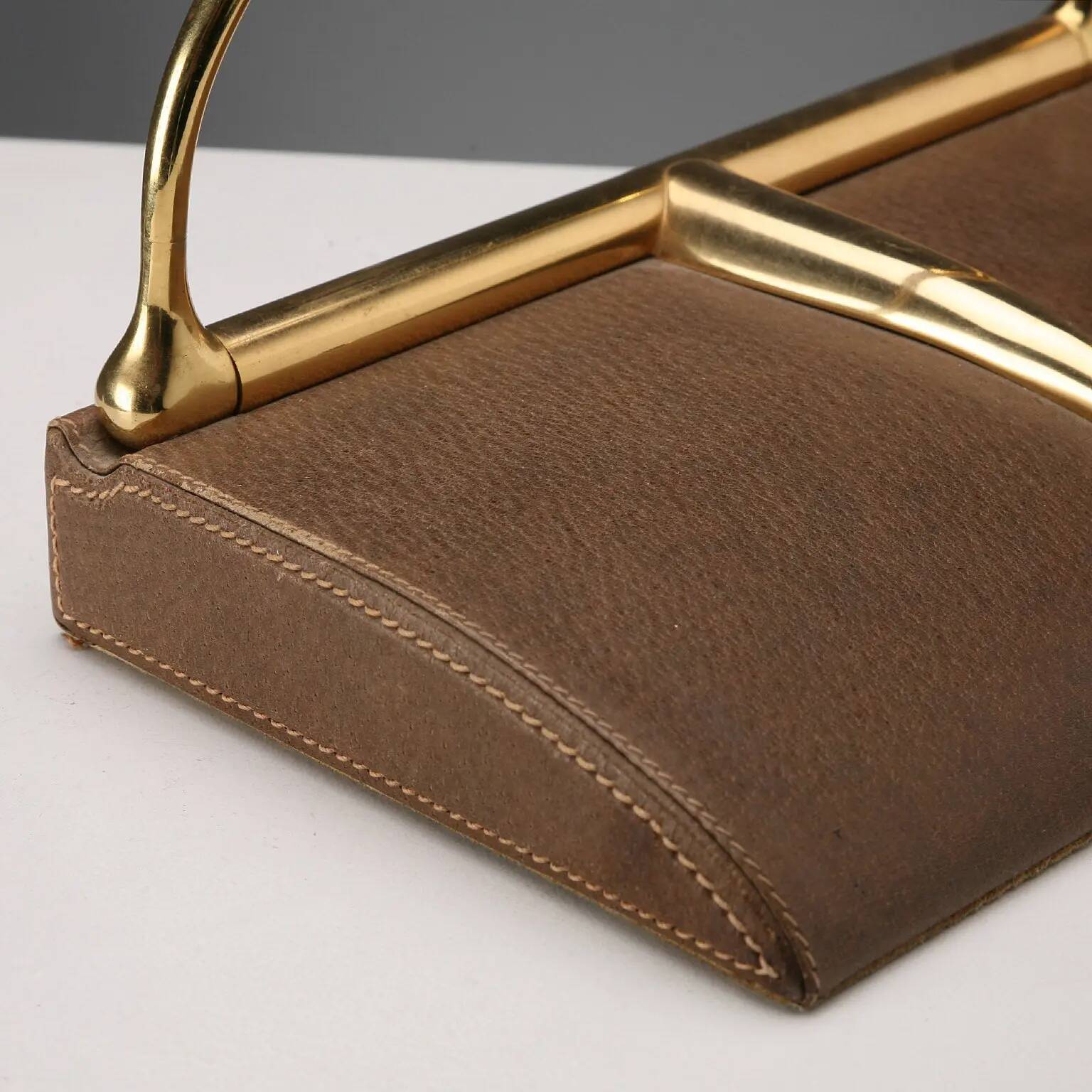 Vintage Gucci bookends in leather and brass, Italy, 1970s.