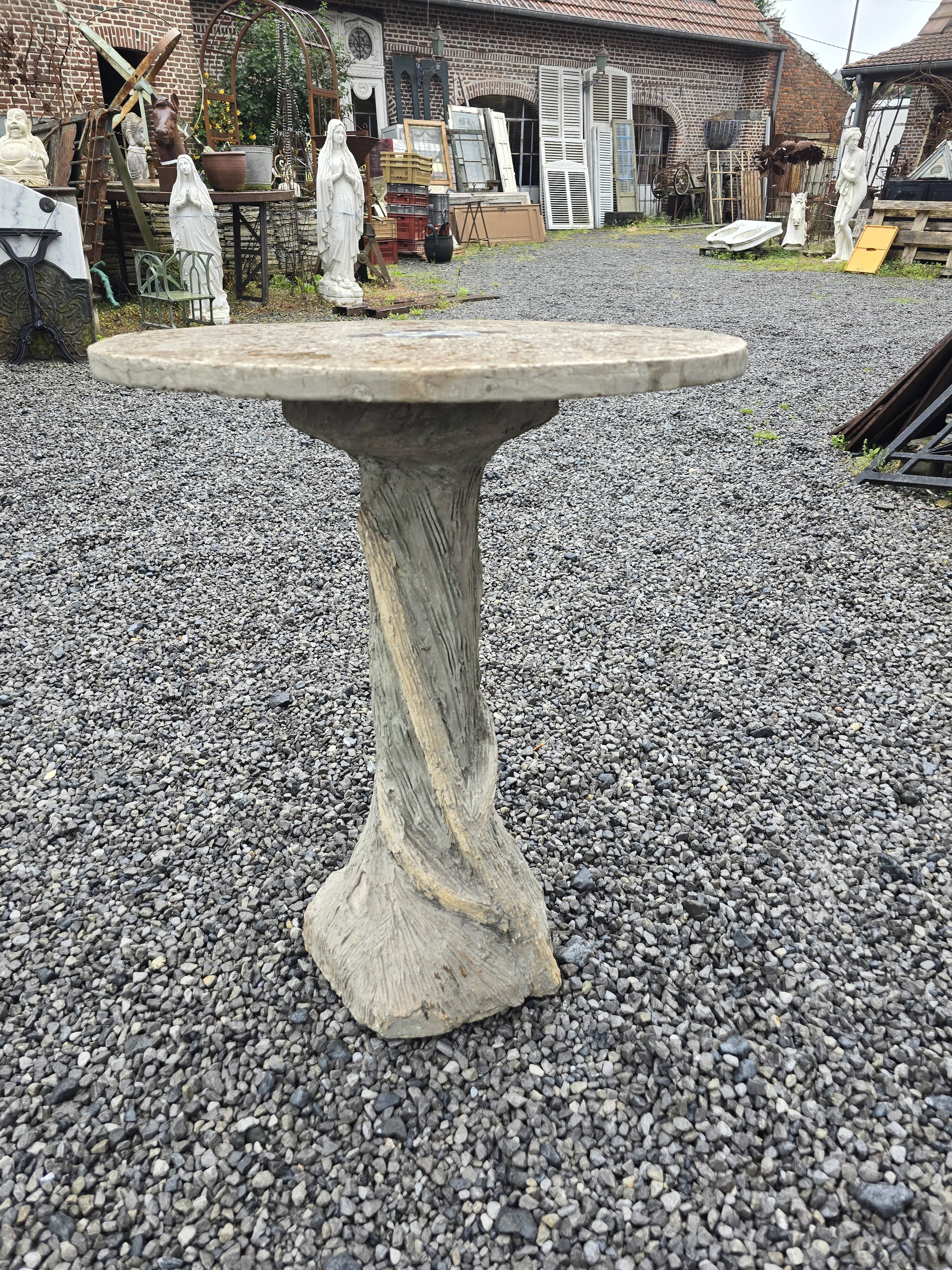 Cement garden table with trunk-shaped foot