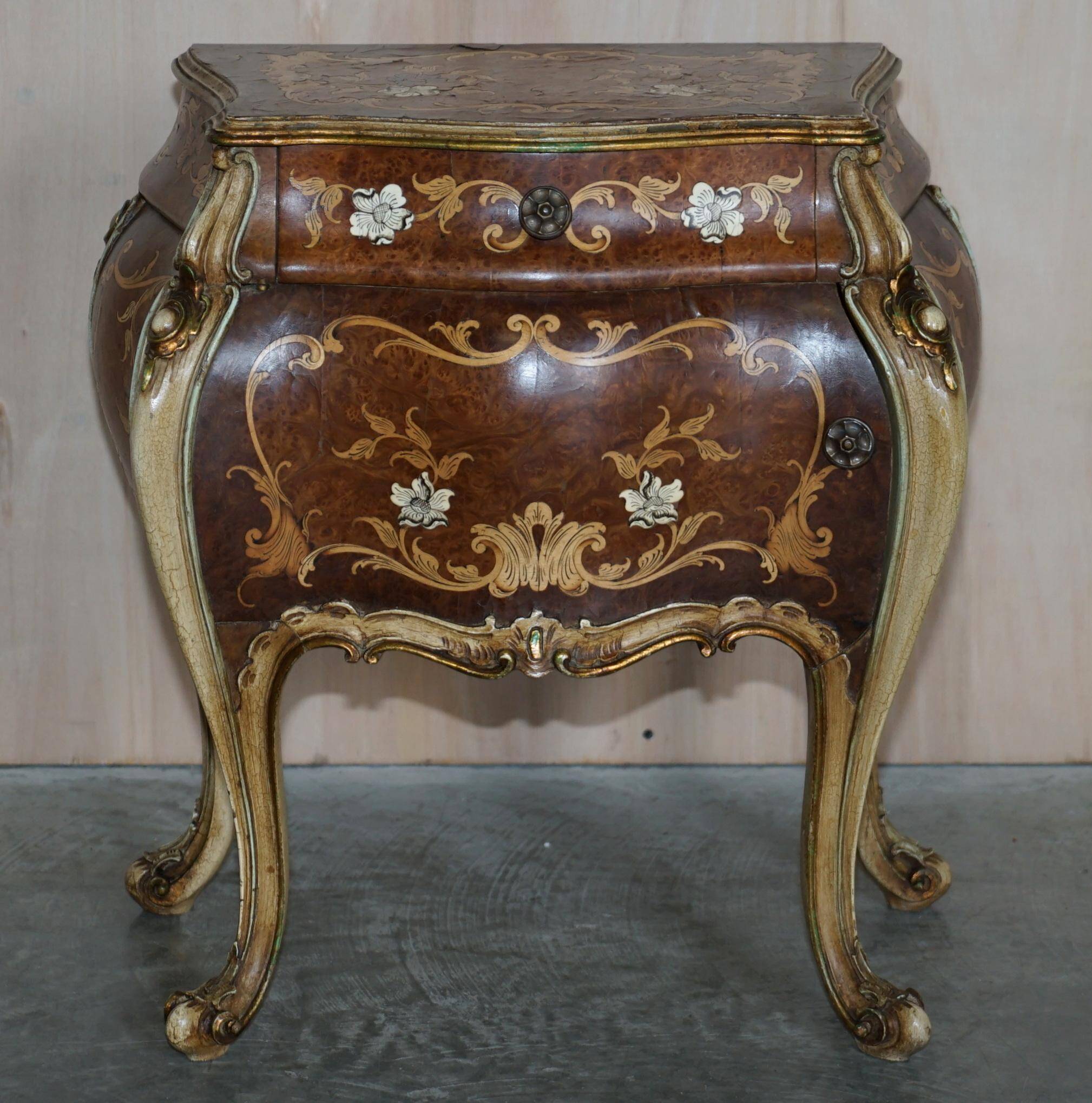 Pair of curved walnut commodes with marquetry and marble tops.