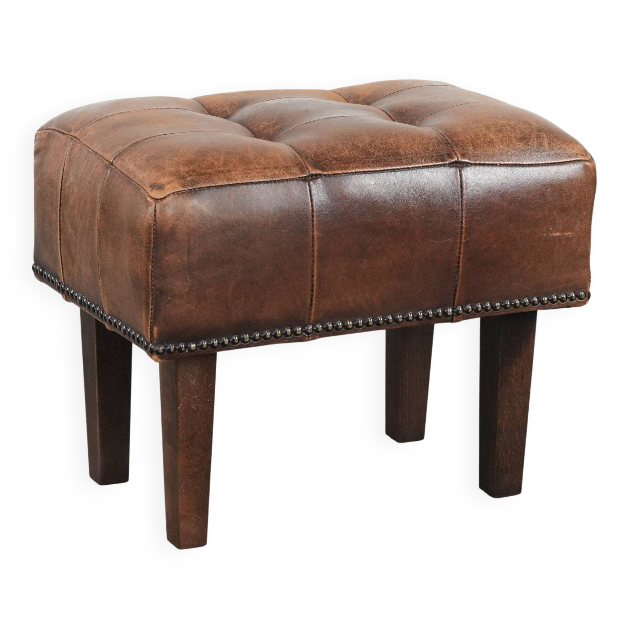 Beautiful sheepskin ottoman on high legs and beautiful warm colours