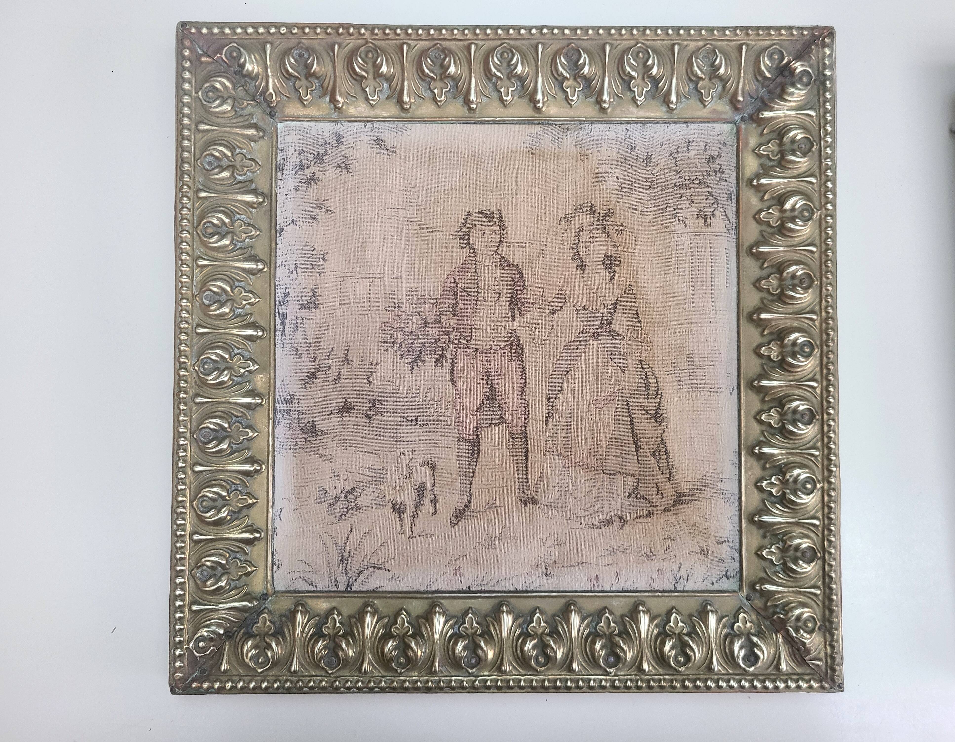 Antique tapestries framed in repoussé brass.