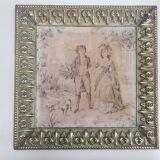 Antique tapestries framed in repoussé brass.